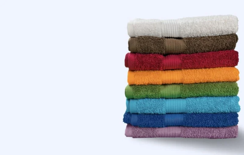 Stack of freshly laundered coloured towels — Dee's Laundry PCB